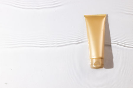 Beauty product tube in water with copy space background on white background. Health and beauty, make...