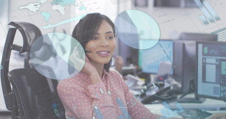 Image of statistics over woman using phone headset working in an office. Digital interface and...