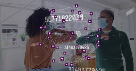 Image of floating numbers and net of connections with colleagues greeting in office wearing face...
