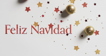 Feliz navidad text in red over stars and christmas baubles on white background. Christmas, decorations, tradition, spanish, greetings and celebration digitally generated image.の写真素材