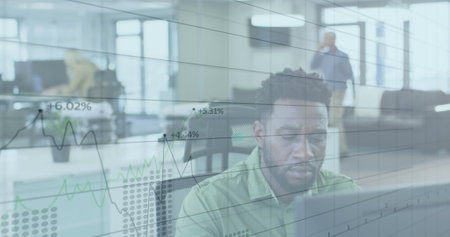 Image of digital interface showing statistics with diverse colleagues working together in an office. Digital interface and global business, digitally generated imageの写真素材