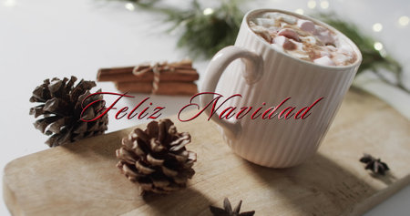 Feliz navidad text in red over pine cones, cinnamon and christmas hot chocolate with marshmallows. Christmas, tradition, spanish, greetings and celebration digitally generated image.の写真素材