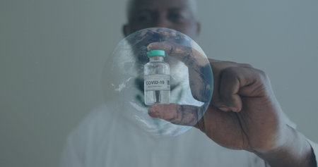 Image of globe spinning with scientist holding covid-19 vaccine. Healthcare and protection during...