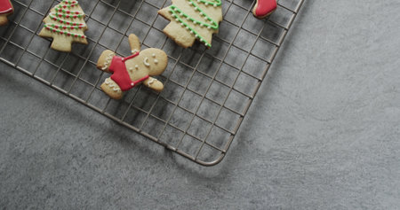 Homemade gingerbread cookies on a cooling rack, with copy space. Captured in a home kitchen, the festive treats suggest holiday baking activities.の写真素材