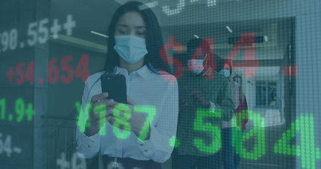 Image of digital interface showing statistics with colleagues in office wearing face masks....
