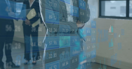 Image of data processing over diverse business people in office. Global finance, business, connections, computing and data processing concept digitally generated image.の写真素材