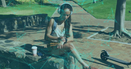 Image of network of connections over woman using smartwatch in a park. Digital interface global...