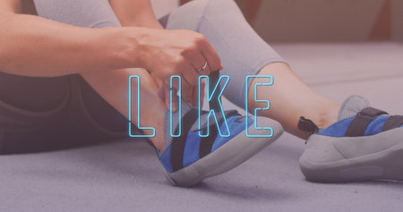 Neon blue like text banner against mid section of woman tying her shoelaces at the gym. sports,...