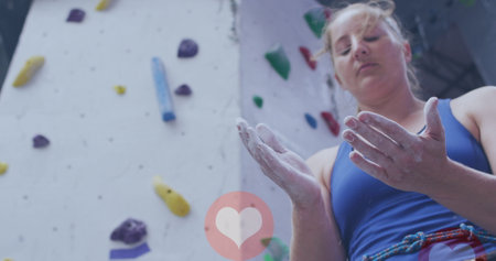 Caucasian fit woman applying chalk to her hands at the gym. sports, fitness and technology conceptの写真素材