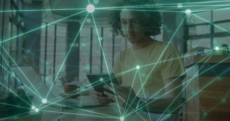 Image of network of connections over biracial man using tablet. Global networks, digital interface, computing and data processing concept digitally generated image.の写真素材