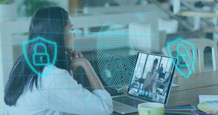 Image of biometric fingerprint over woman using laptop on image call in background. Digital...