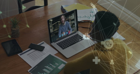 Image of networks of connections over woman using laptop on image call. Digital interface global...
