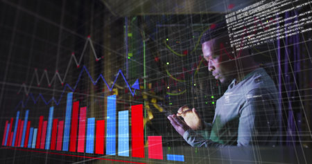 Image of graphs over african american man working in server room. network, programming, computers...