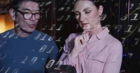 Image of binary code over diverse woman and man working in server room. network, programming, computers and technology concept digitally generated image.の写真素材
