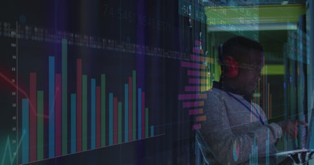 Image of graphs over african american man working in server room. network, programming, computers...