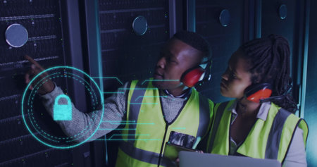 Image of digital padlock over african american man and woman working in server room. network, programming, computers and technology concept digitally generated image.の写真素材