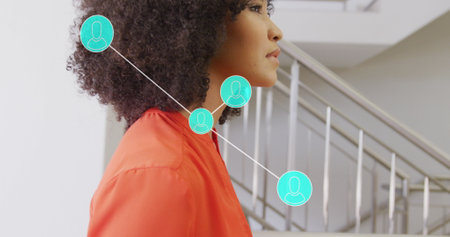 Image of networks and data processing over african american businesswoman in office. Global networks, business, finances, computing and data processing concept digitally generated image.の写真素材