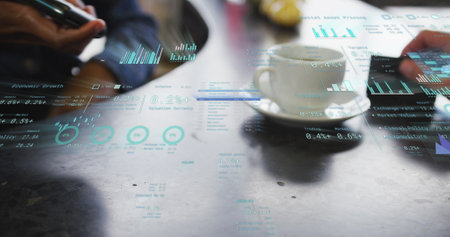 Image of financial data over caucasian businessman paying with card on payment terminal. Global business, finances, computing and data processing concept digitally generated image.の写真素材