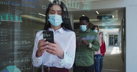 Image of financial data over diverse business people in face masks queueing in corridor. Global covid 19, business, finances, computing and data processing concept digitally generated image.の写真素材