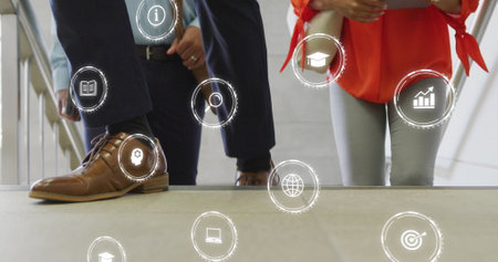 Image of digital icons over diverse business people in office. Global networks, business, finances, computing and data processing concept digitally generated image.の写真素材