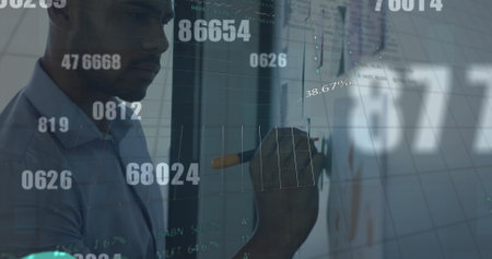 Changing numbers and financial data processing against man writing on memo notes on white board. global business and finance conceptの写真素材