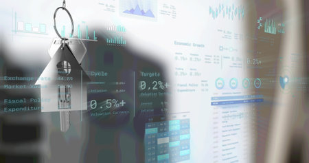 Image of financial data processing over silver key and keyfob. Global networks, business, finances, computing and data processing concept digitally generated image.の写真素材