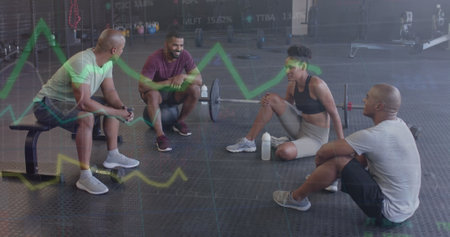 Image of data processing on graph over diverse fitness group sitting talking at gym. Fitness, exercise, friendship, data, digital interface and technology digitally generated image.の写真素材