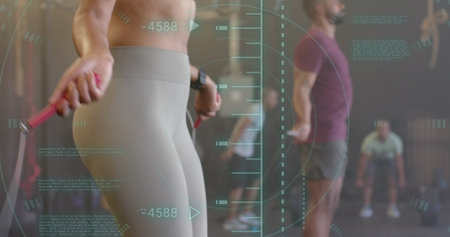 Image of data processing over diverse woman and man jumping rope cross training at gym. Fitness, exercise, strength, data, digital interface and technology digitally generated image.の写真素材