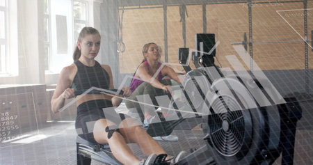 Image of data on interface over caucasian women training on rowing machines at gym. Fitness,...