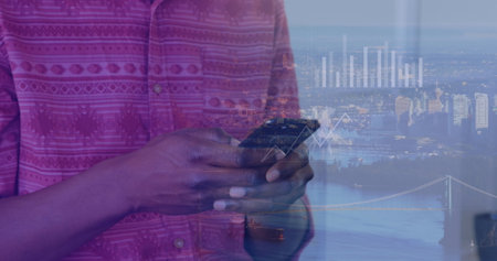 Image of african american businessman using smartphone over data and cityscape. Global business, finances, digital interface, computing and data processing concept digitally generated image.の写真素材
