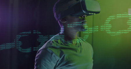 Image of chain over african american man using vr headset in server room. Cloud computing, digital...