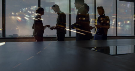 Image of diverse business people in office over cityscape. Global business, finances, digital interface, computing and data processing concept digitally generated image.の写真素材