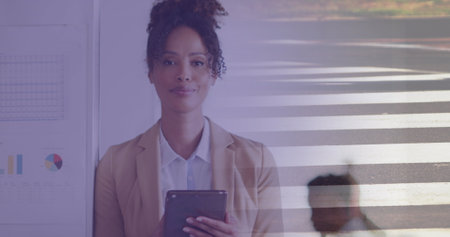 Image of biracial businesswoman in office over people walking and cityscape. Global business, finances, digital interface, computing and data processing concept digitally generated image.の写真素材