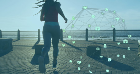 Image of network of connections over woman jogging on promenade by the sea. digital interface global sport and performance concept digitallygenerated image.の写真素材