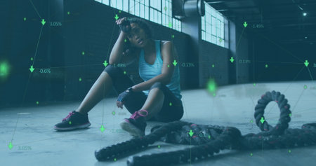 Image of statistics and graphs over woman breathing heavily. Digital interface global sport and...