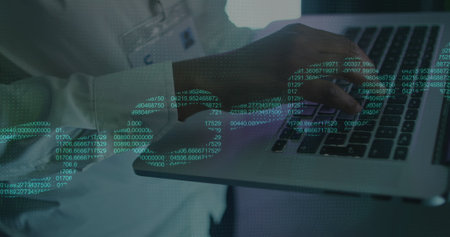 Image of digital chain over african american man using laptop in server room. Cloud computing, digital interface and security concept digitally generated image.の写真素材