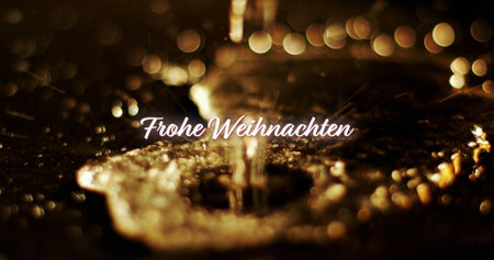 Image of frohe wihnachten text over gold liquid falling on black background. Christmas, tradition and celebration concept digitally generated image.の写真素材