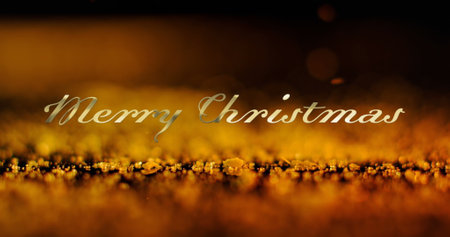 Image of merry christmas text over orange particles falling on black background. Christmas, tradition and celebration concept digitally generated image.の写真素材
