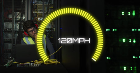 Image of speedometer over biracial man using laptop in server room. Cloud computing, digital...