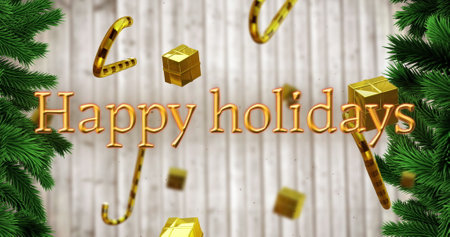 Image of happy holidays text over christmas candy canes on grey background. Christmas, tradition and celebration concept digitally generated image.の写真素材