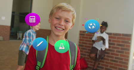 Image of school icons over smiling caucasian schoolboy with schoolbag in school corridor. School, education, childhood and learning, digitally generated image.の写真素材