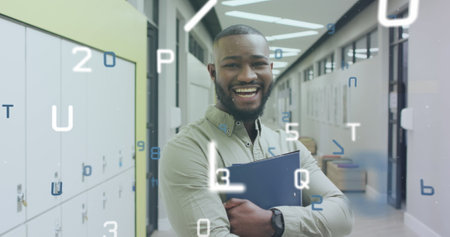 Image of data processing over laughing african american male teacher in school corridor. School, education, teaching and learning, digitally generated image.の写真素材