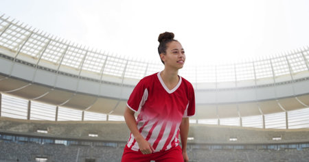Image of biracial female soccer player over stadium. Global sport, patriotism and digital interface concept digitally generated image.の写真素材
