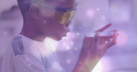 Image of light particles over african american schoolboy studying petri dish in science class. Science, school, education, childhood and learning, digitally generated image.の写真素材