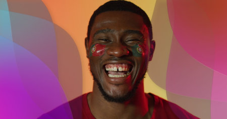 Image of african american male supporter with flag of portugal over shapes. Global sport and digital...