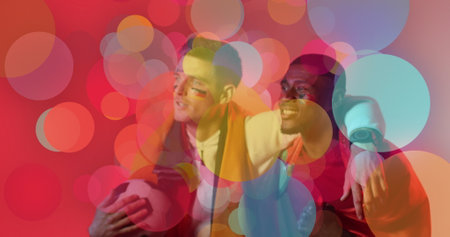 Image of diverse male supporters with flags of portugal and germany over spots. Global sport and digital interface concept digitally generated image.の写真素材