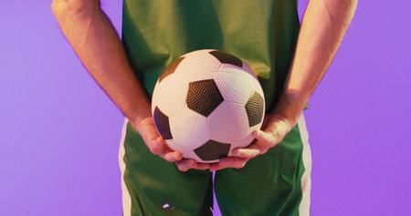 Image of caucasian male soccer player over confetti. Global sport and digital interface concept digitally generated image.の写真素材