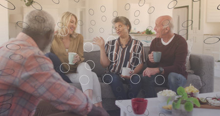 Image of media icons over diverse group of seniors talking. senior home hangout and digital interface concept digitally generated image.の写真素材