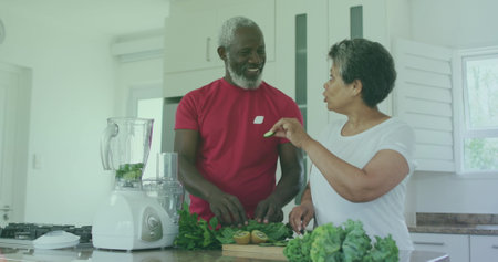 Image of bio super foods texts over senior african american couple cooking. senior home hangout and digital interface concept digitally generated image.の写真素材