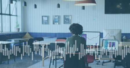 Image of data processing over african american businesswoman working in office. Global business and digital interface concept digitally generated image.の写真素材